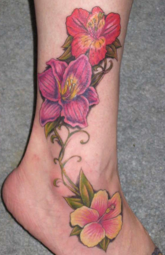 Colourful lilies tattoo on leg