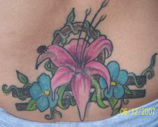 Lily blossom on zodiac symbol tattoo