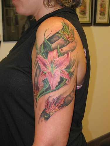 Lily flower and fallen leaves tattoo
