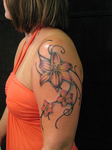 Tribal lilies tattoo on shoulder