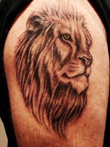 Lion head black ink tattoo on shoulder