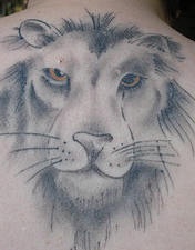 Lion face black ink tattoo