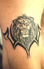 Lion head on tribal armband tattoo