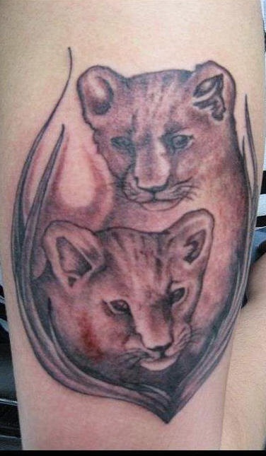 Two lion cubs tattoo