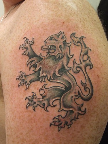 Roaring heraldic lion tattoo on shoulder