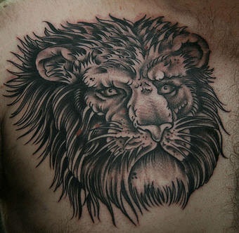 Black ink lion tattoo on chest