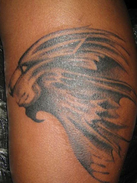 Lion profile black ink tattoo