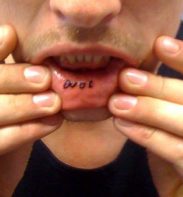Lip tattoo, little letters, ojoe, black inscription
