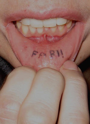 Lip tattoo, far,  emphasized word