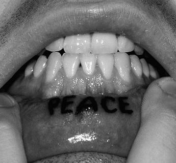 Lip tattoo, peace, bold, black inscription