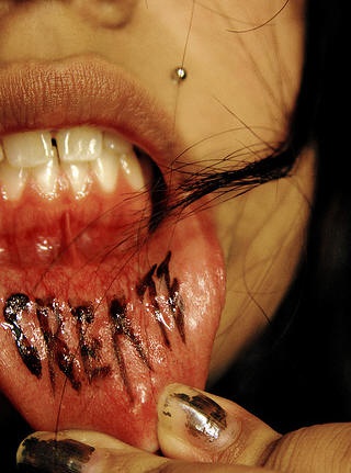 Lip tattoo, bloody, pounded inscription