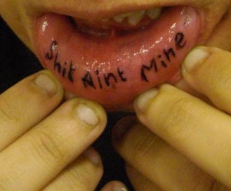 Lip tattoo, shit aint mine, black inscription