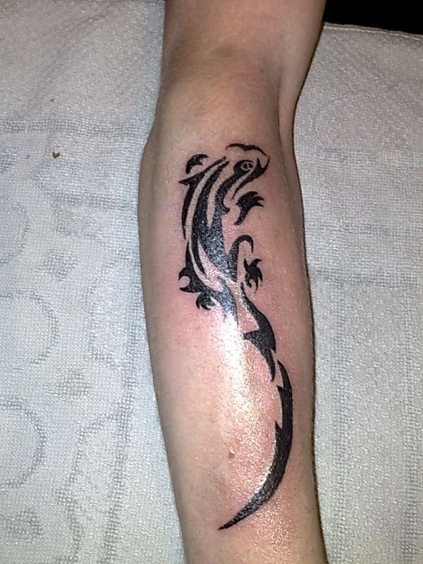 Tribal lizard tattoo on arm