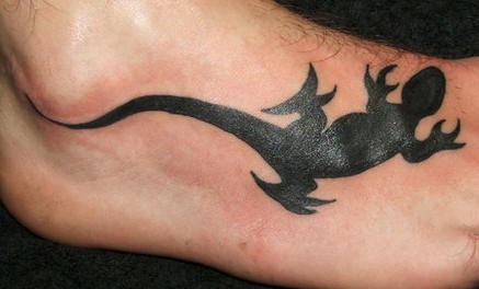 Full black lizard tattoo on foot