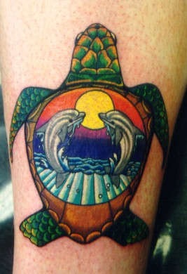 Dolphins in turtle image tattoo