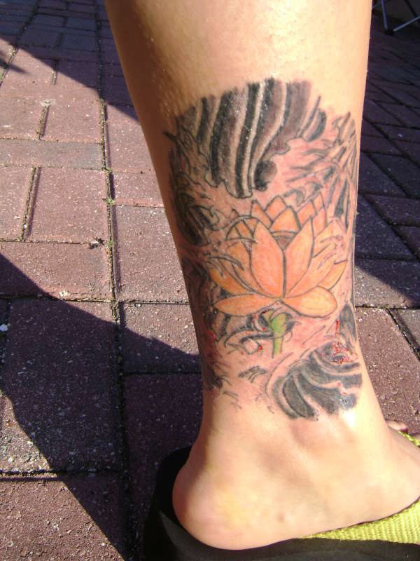 Asian style lotus tattoo on leg