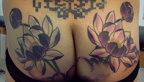 el tatuaje simetrico de flores de loto hecho las nalgas