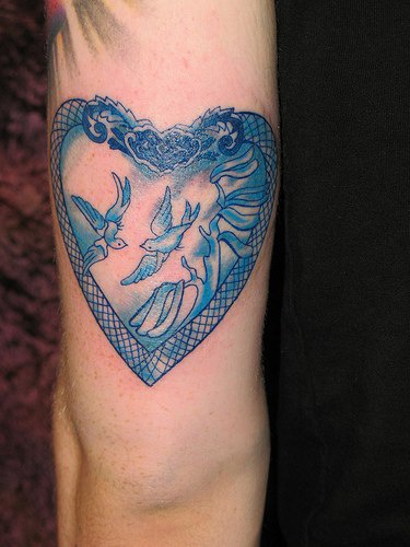 Whire doves in heart pattern tattoo