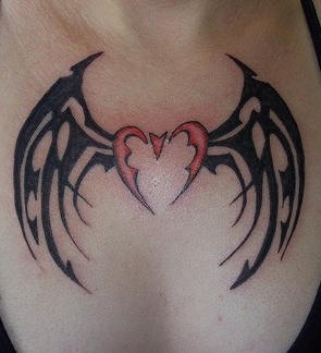 Tribal heart with bat wings tattoo