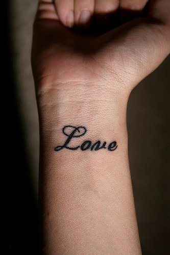 Love word tattoo on wrist