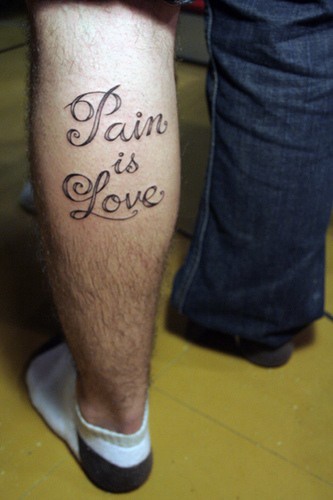 Pain is love tattoo on leg