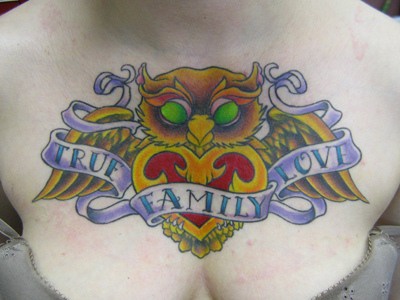 True family love golden owl tattoo on chest