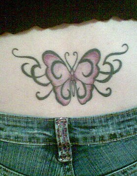Lower back tattoo, decorated, pale butterfly, with black curls