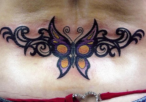 Lower back tattoo, bright black styled butterfly