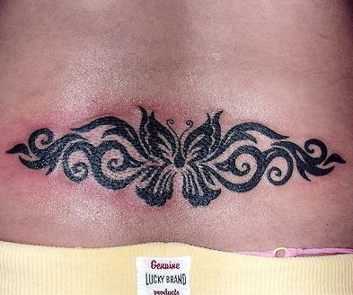 Lower back tattoo, black designed butterfly in pattern