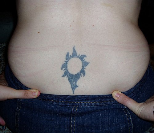 Lower back tattoo, designed flower like a sun-flower