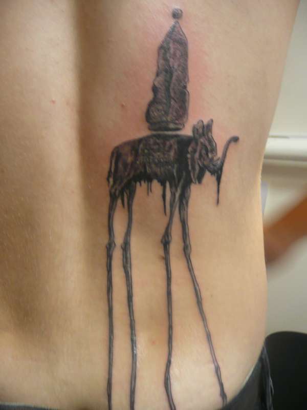 Lower back tattoo, tall, dreadful elephant-monster bearing smth