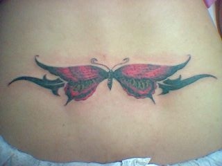 Lower back tattoo, flattened , black and red butterfly