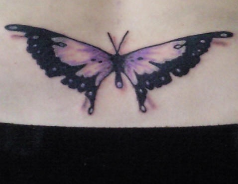 Lower back tattoo,violet  flattened butterfly