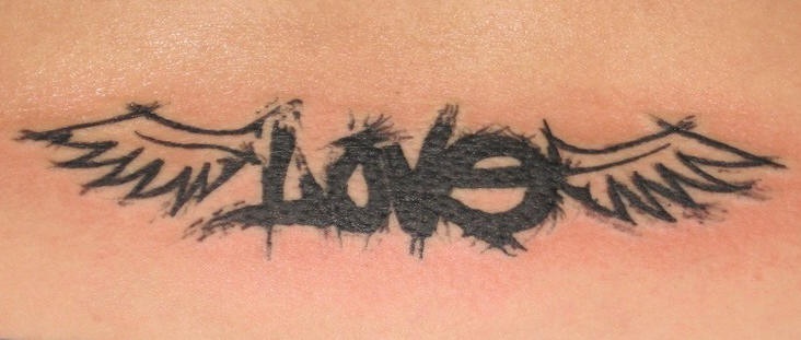 Winged love word tattoo on lower back