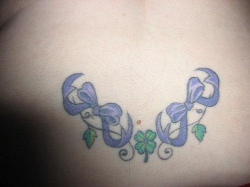 Lower back tattoo, three leaves, clover,nice  bows