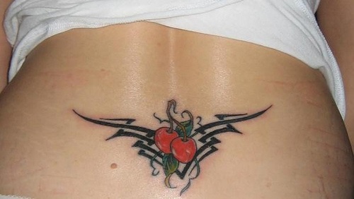 Lower back tattoo, two red cherries in black styled pattern