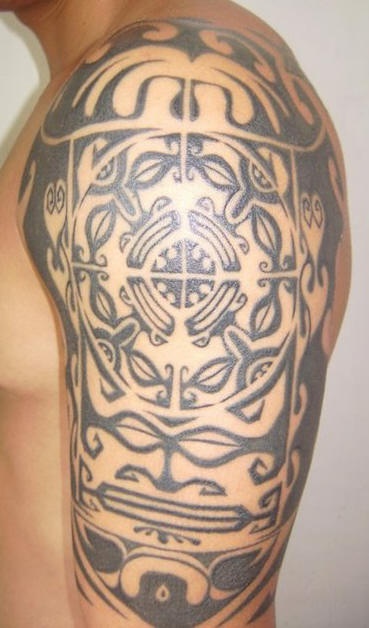 Maori black tribal tattoo on shoulder