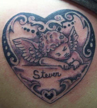 Sleeping cherub in heart nemorial tattoo
