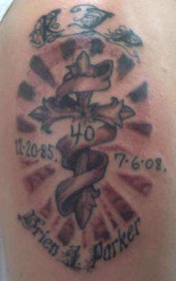 Cross in stripe and shining memorial tattoo