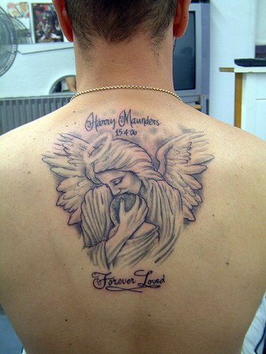 Tattoo in loving memory on back