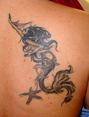 Detailed mermaid with starfish tattoo