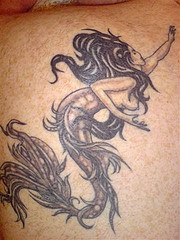 Regular black ink mermaid tattoo
