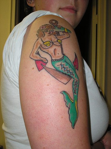 Blonde mermaid on anchor tattoo