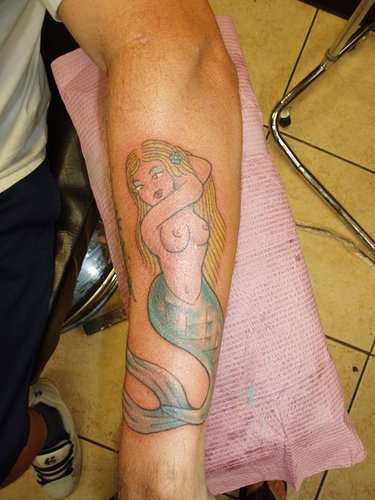 Naked blonde mermaid sailor tattoo
