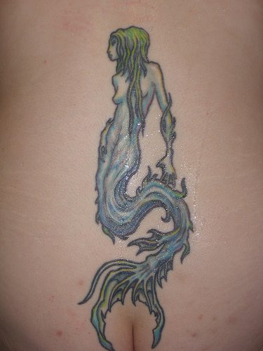 Green haired mermaid tattoo on lower back