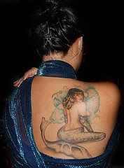 Brunette mermaid tattoo on back
