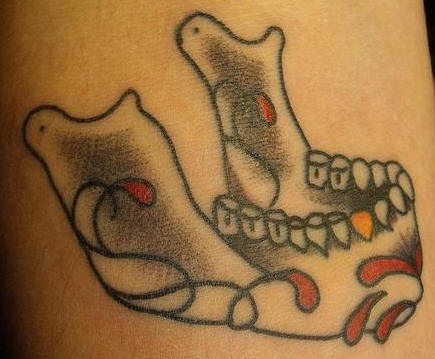 Sugar skull mandible with golden tooth tattoo
