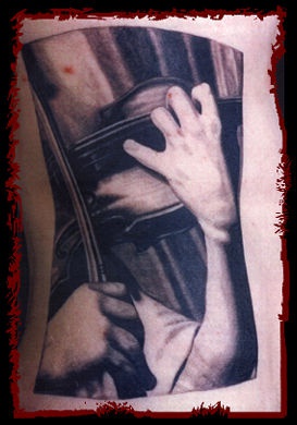 Tattoo of man playing violin on photo