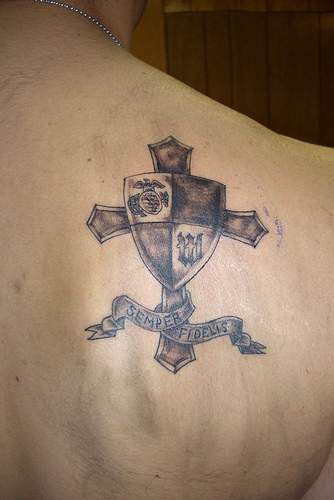 Cross with army shield tattoo on shoulder