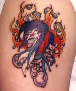 Joker faces in flame comics tattoo